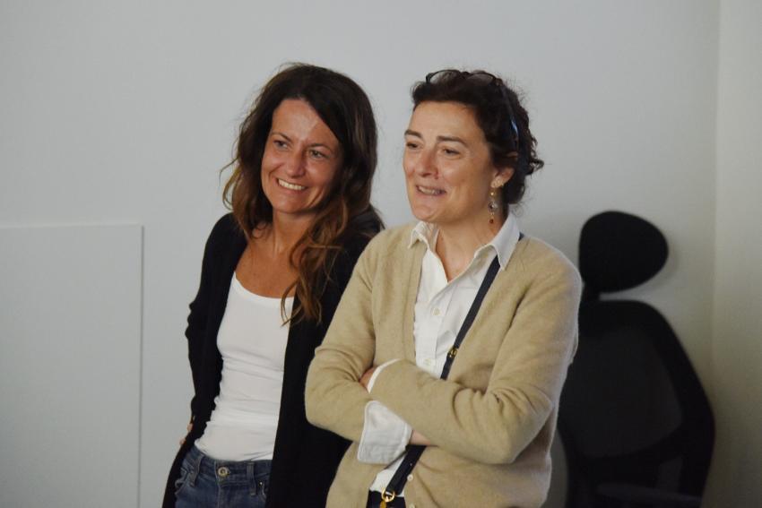 Margherita and Giuliana standing beside each other smiling. 