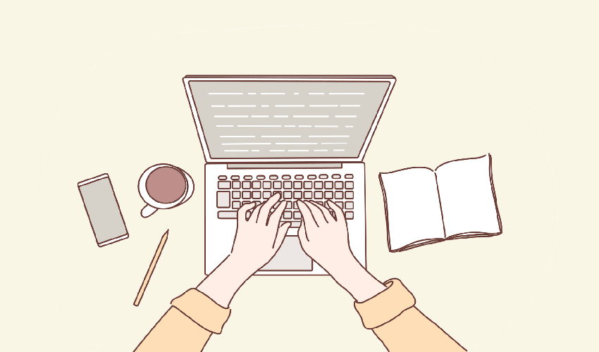 writing on laptop with coffee and notebook