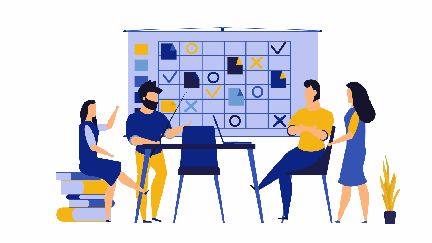 2 men and 2 women standing and sitting discussing a table on a whiteboard