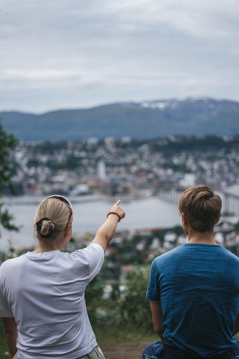 Photo of students in nature looking towards the city