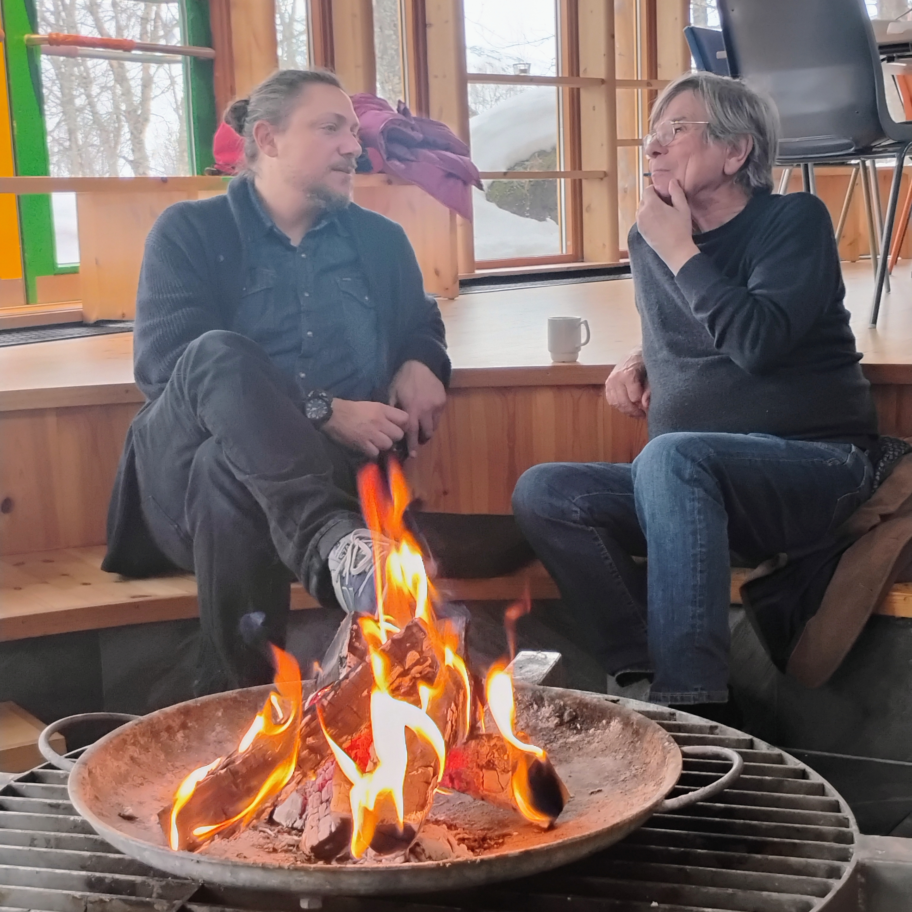 Nandor and Hans-J&ouml;rg sitting by the fireplace talking during lunch