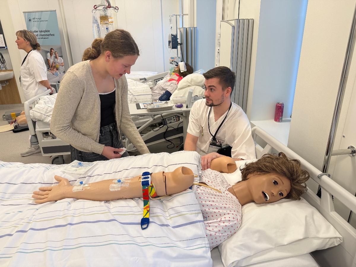 Sykepleierstudent viser p&aring; en dukke hvordan en elev skal sette en veneflon